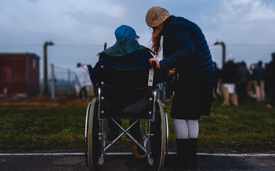 woman standing with another person in wheelchair-image credit-unsplash-philippians-unity-christians